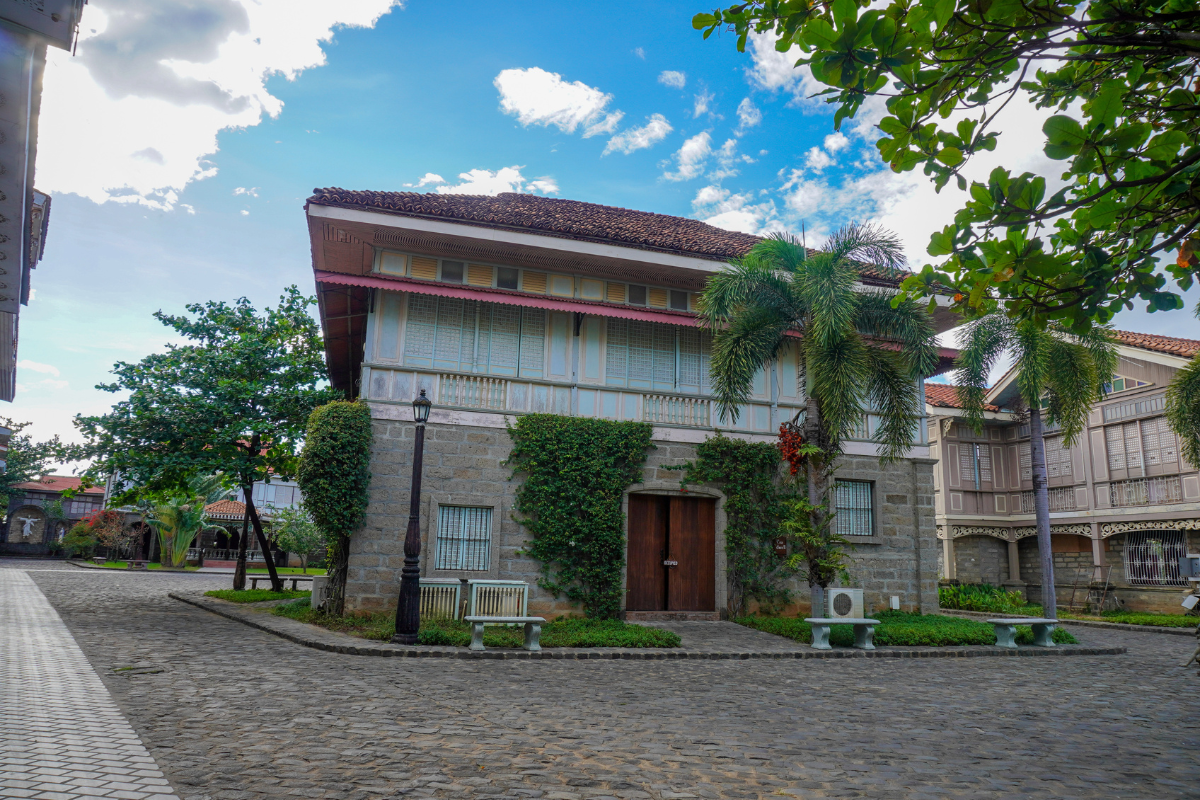 a building with trees and plants on the side