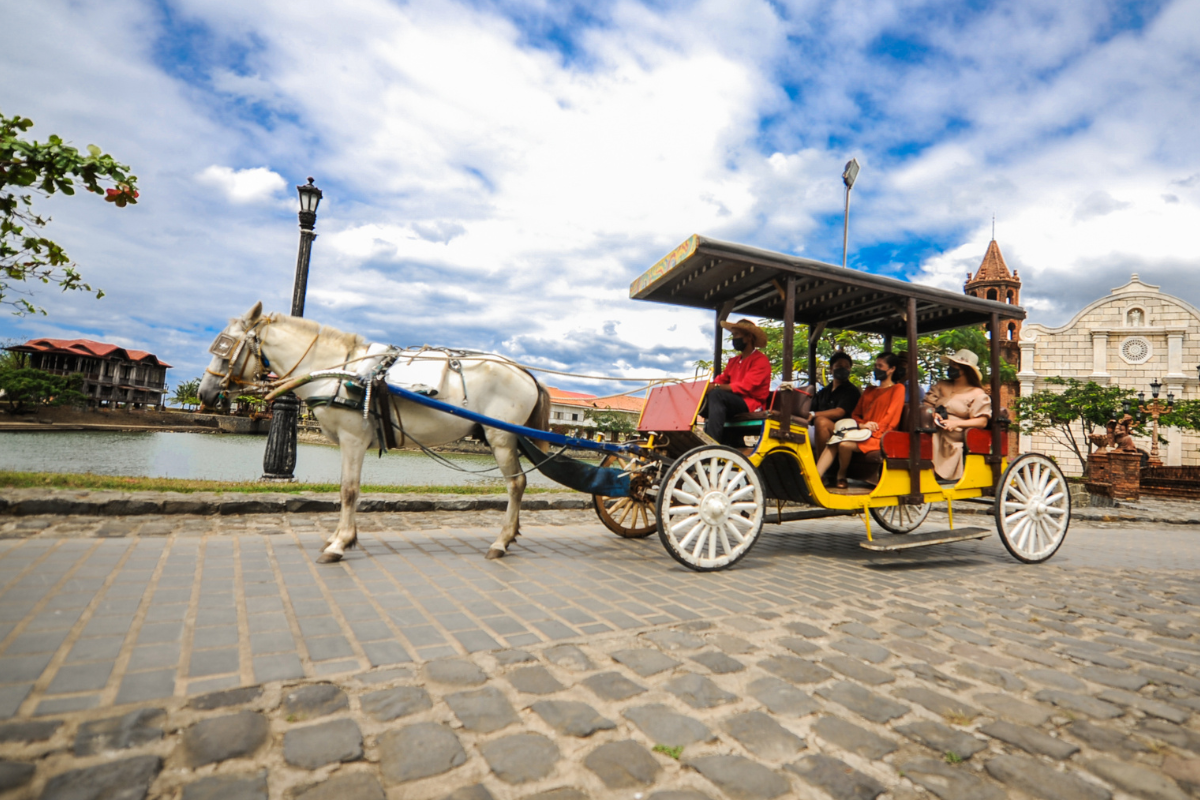 a horse carriage with people on it
