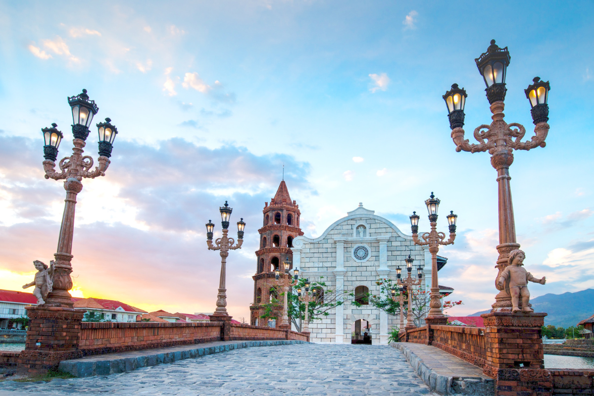 a stone bridge with a clock tower and street lights