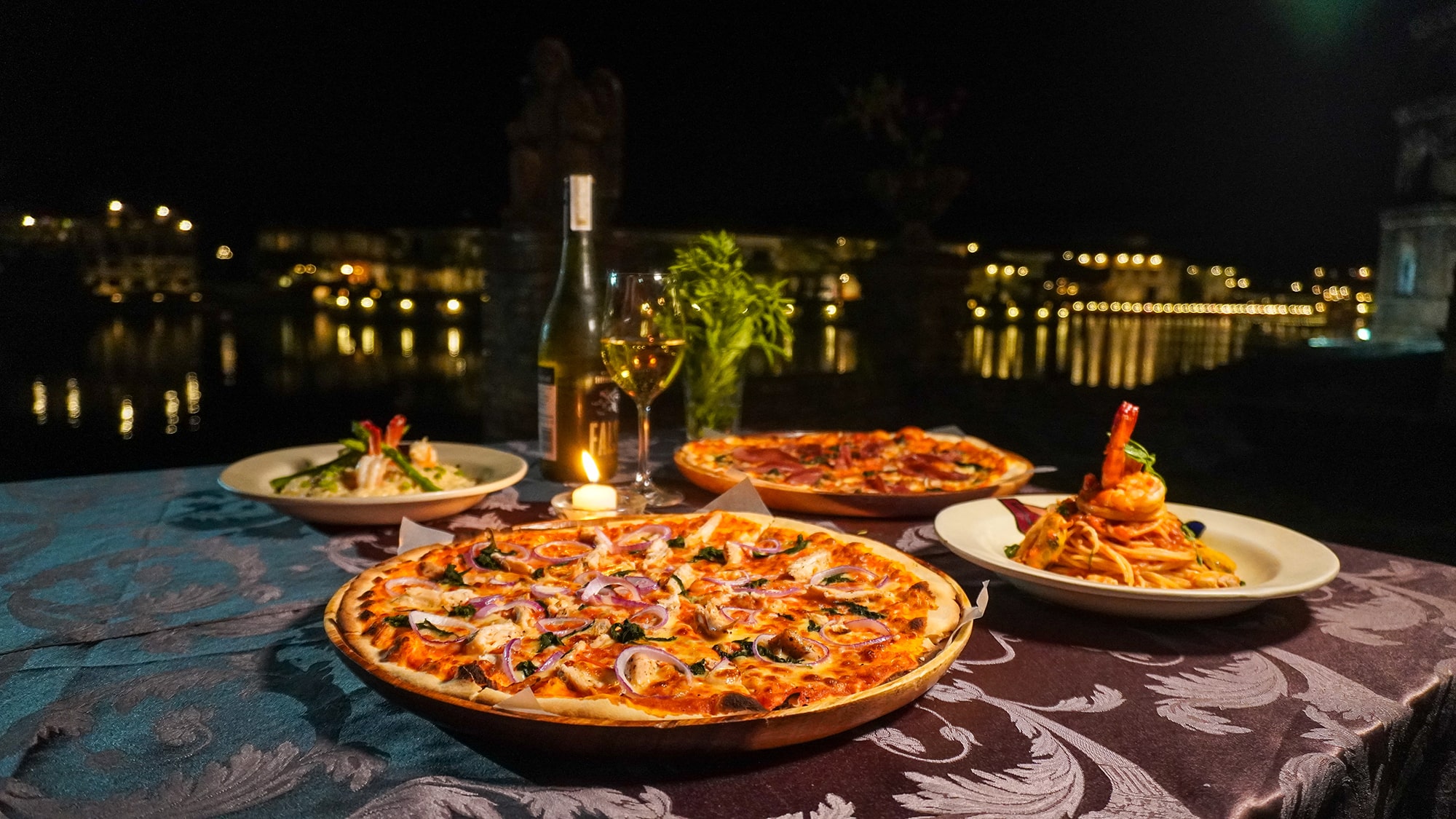 a table with plates of food and wine
