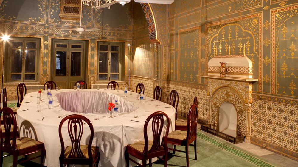 a room with a round table and chairs