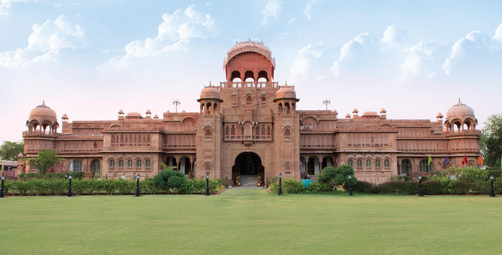 a large building with a lawn and a lawn with Lahore Museum in the background