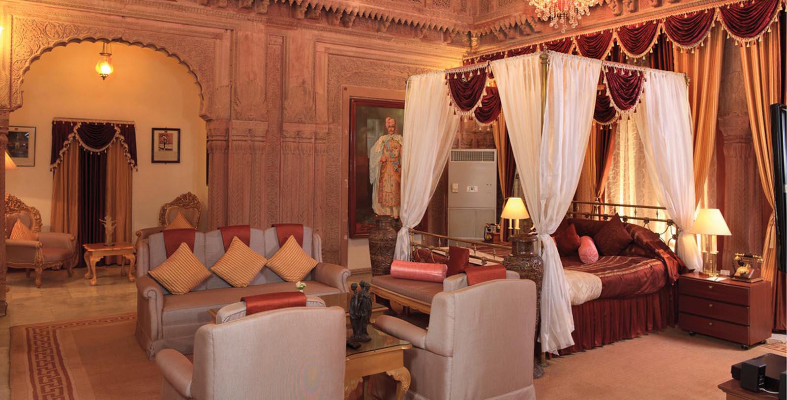 a room with a bed and couches