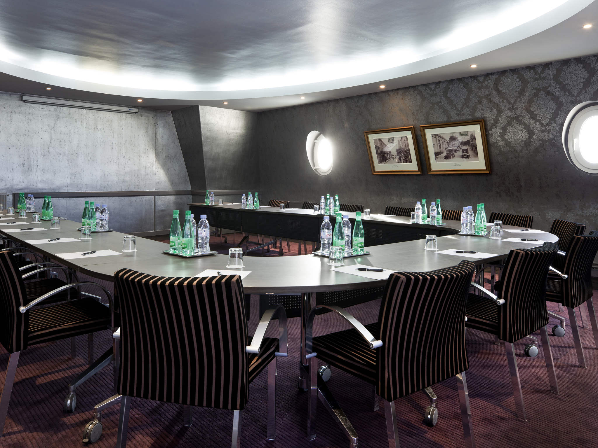 a room with a round table and chairs