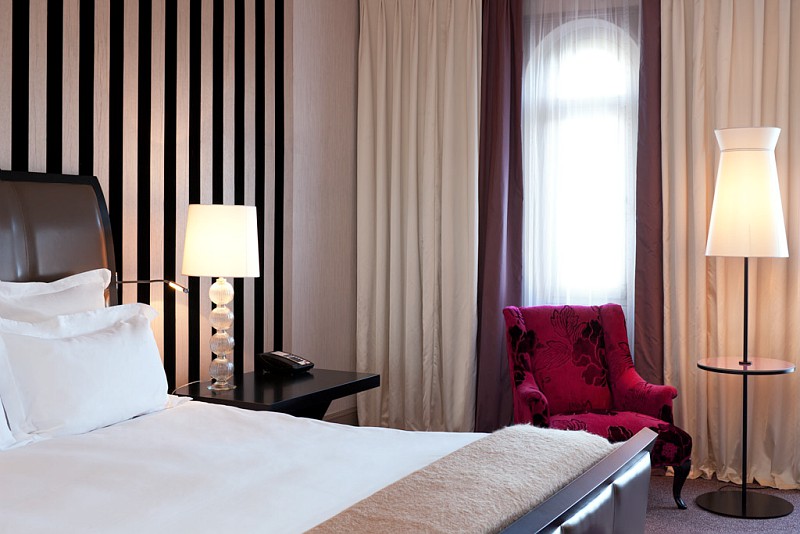 a bedroom with a bed and a lamp