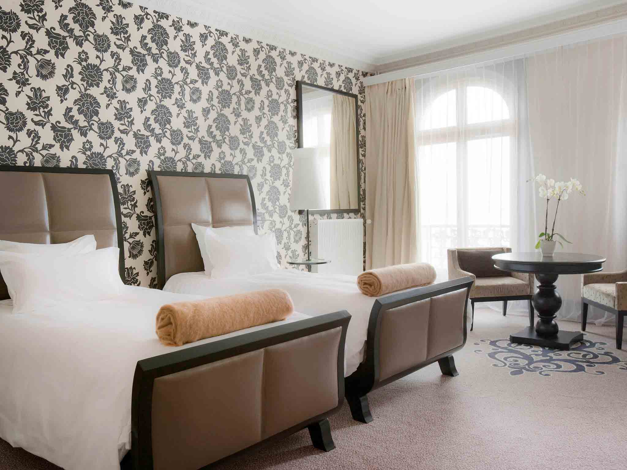 a room with two beds and a table