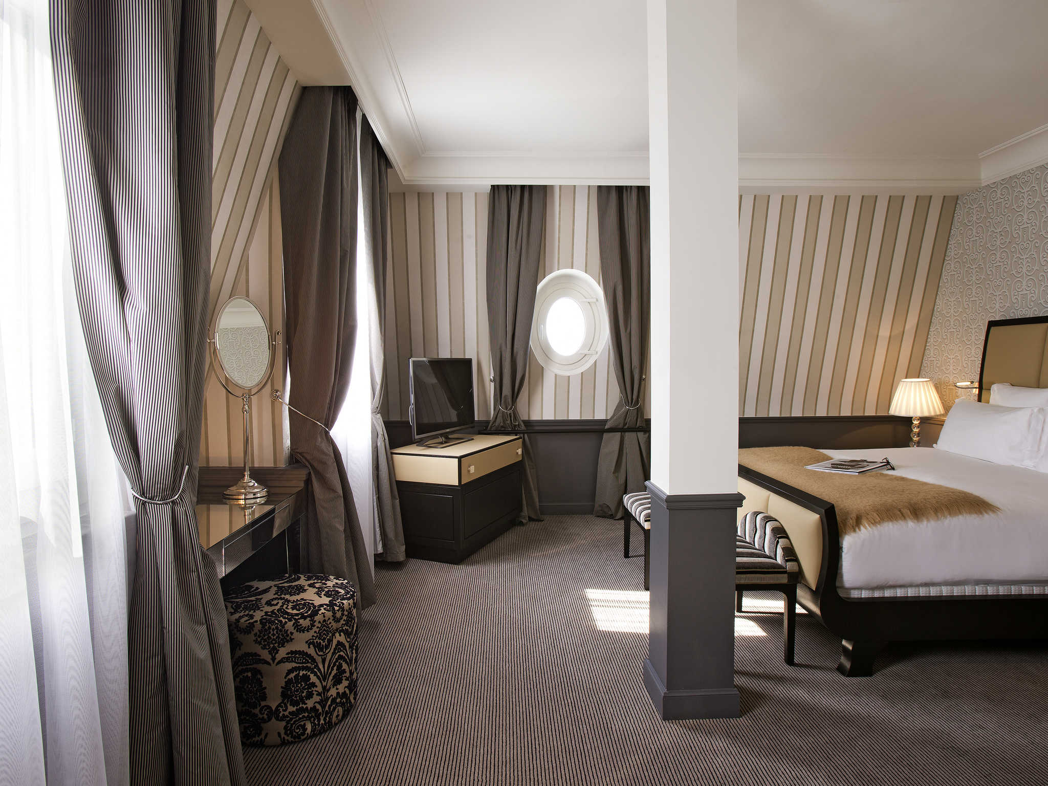 a room with a bed and a television
