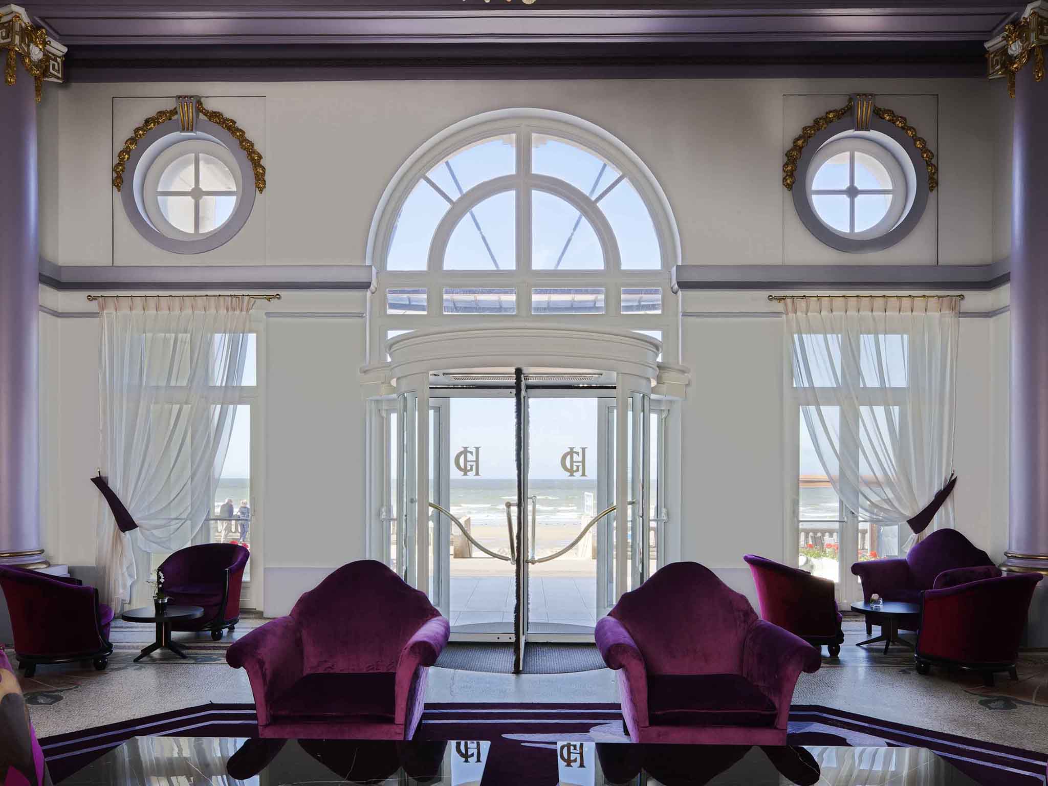 a room with purple chairs and a glass door