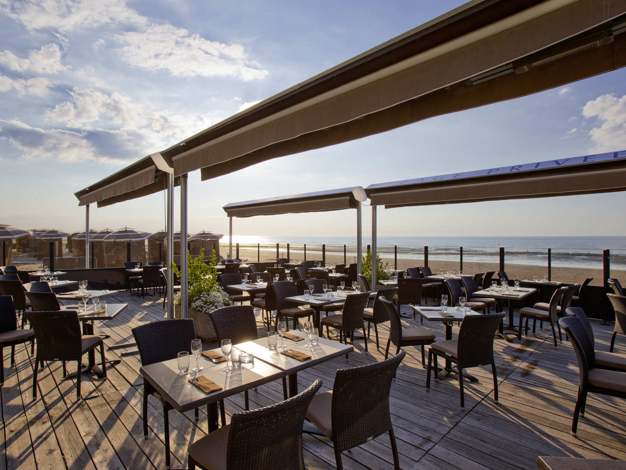 a restaurant with tables and chairs on a deck