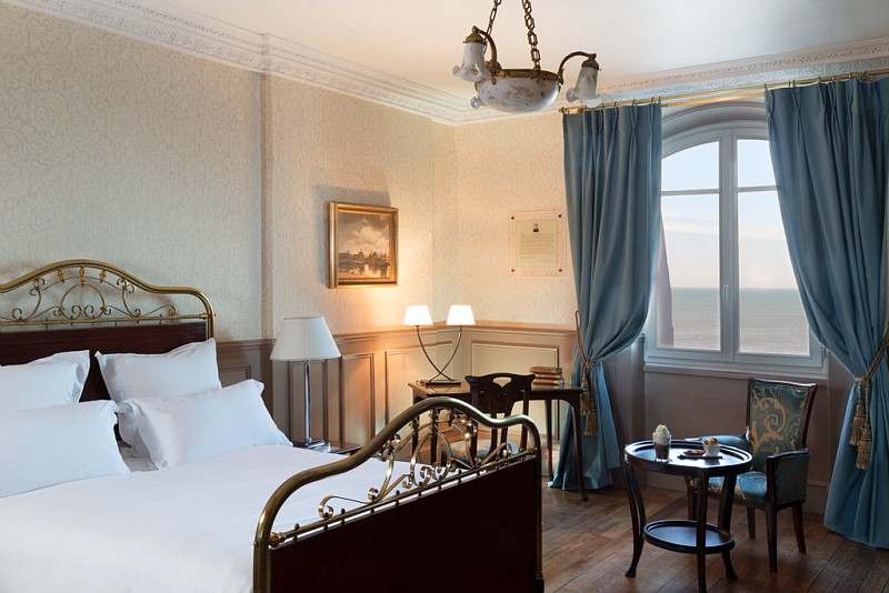 a bedroom with a bed and a table