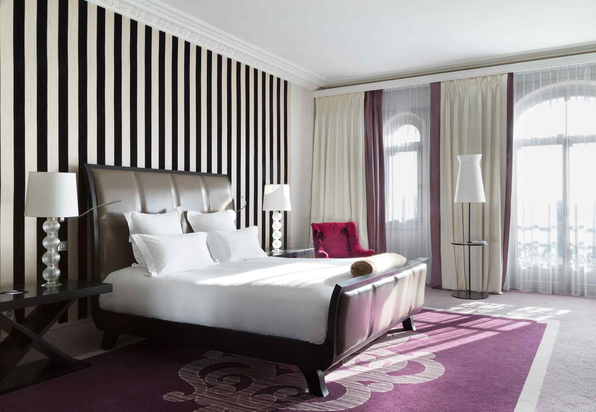 a room with a bed and purple carpet