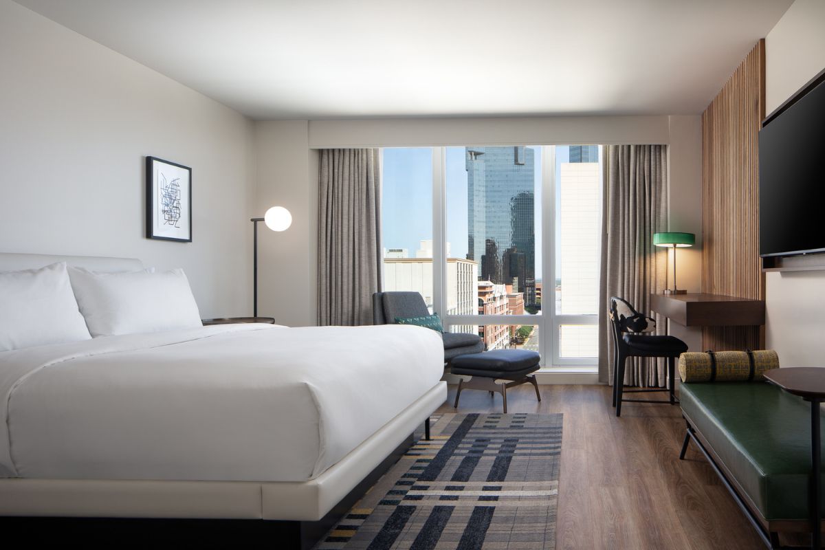 a room with a bed and a desk and chair