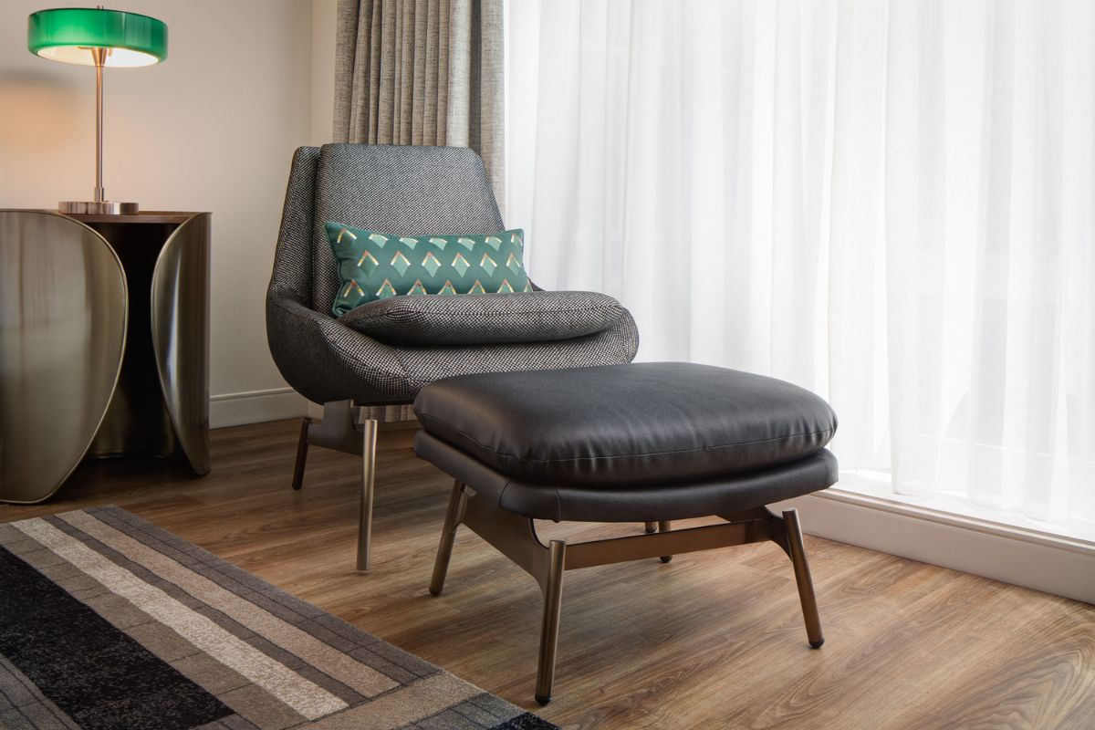 a chair and ottoman in a room