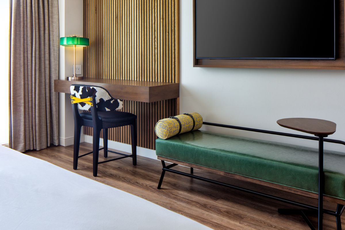 a room with a green couch and a tv