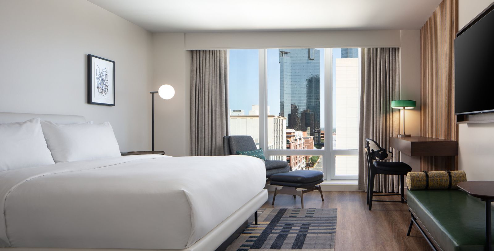 a hotel room with a large window and a bed