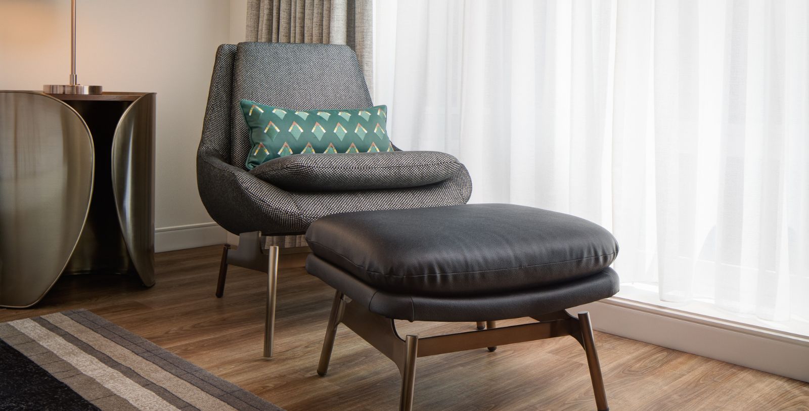a chair and ottoman in a room