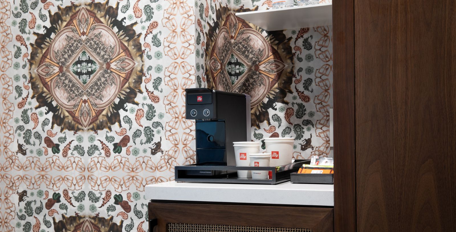 a coffee machine and cups on a counter