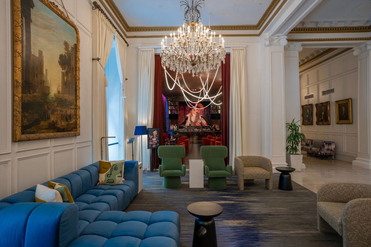 a room with a chandelier and couches
