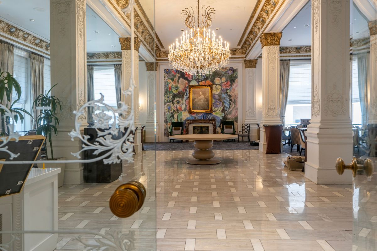 a large room with a chandelier and a painting on the wall