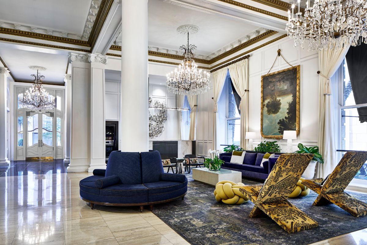 a large room with a large couch and a chandelier