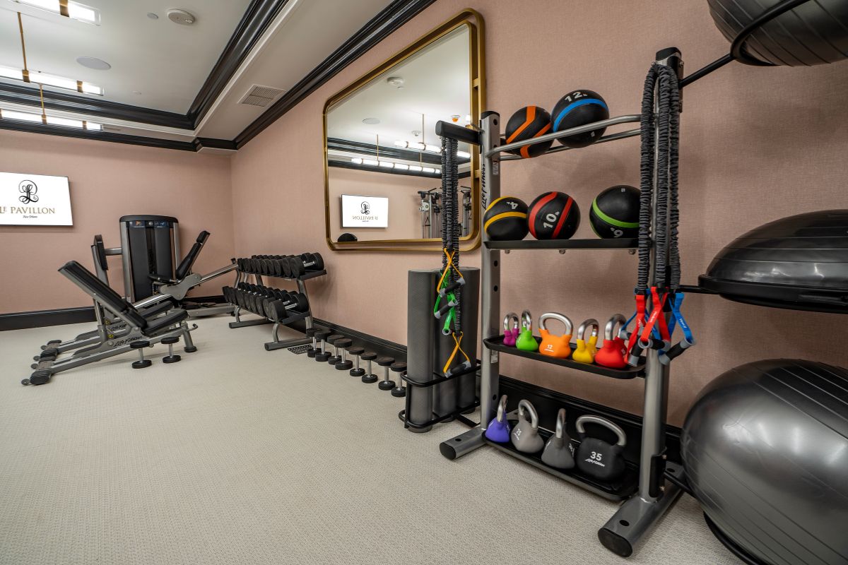 a room with exercise equipment and a mirror