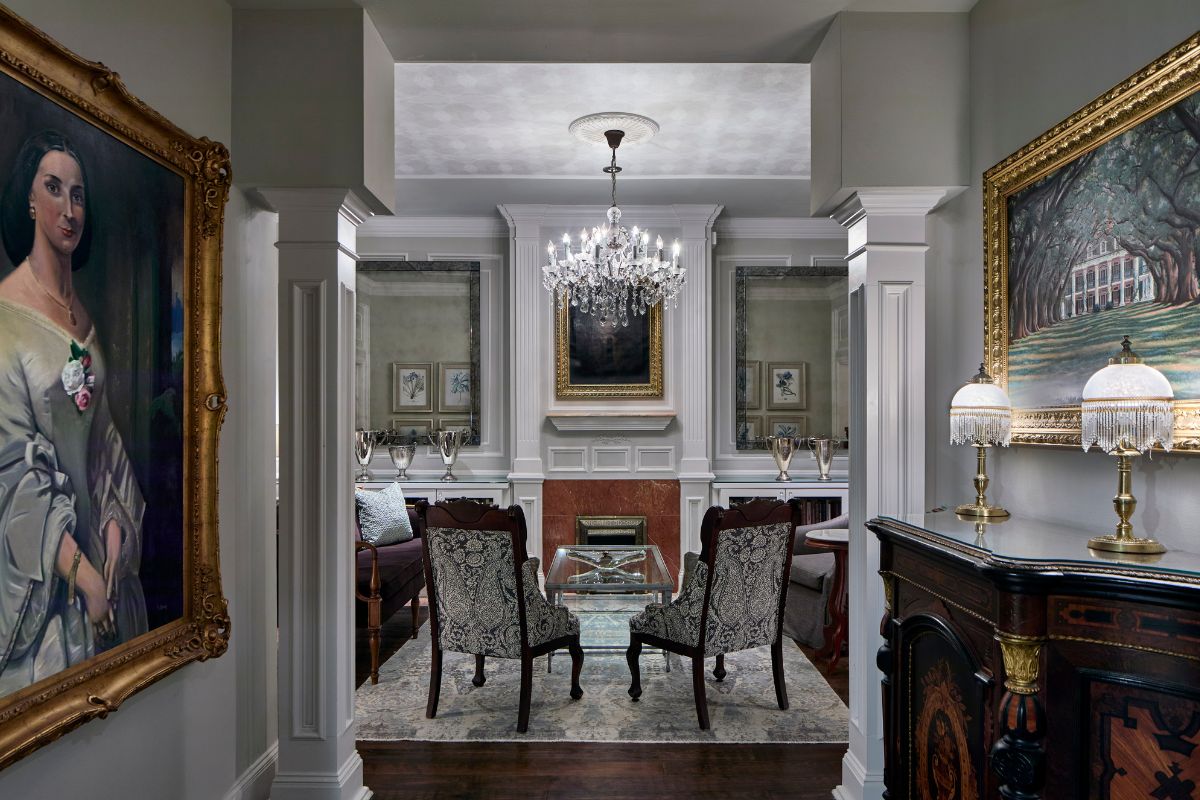 a room with chandelier and chairs
