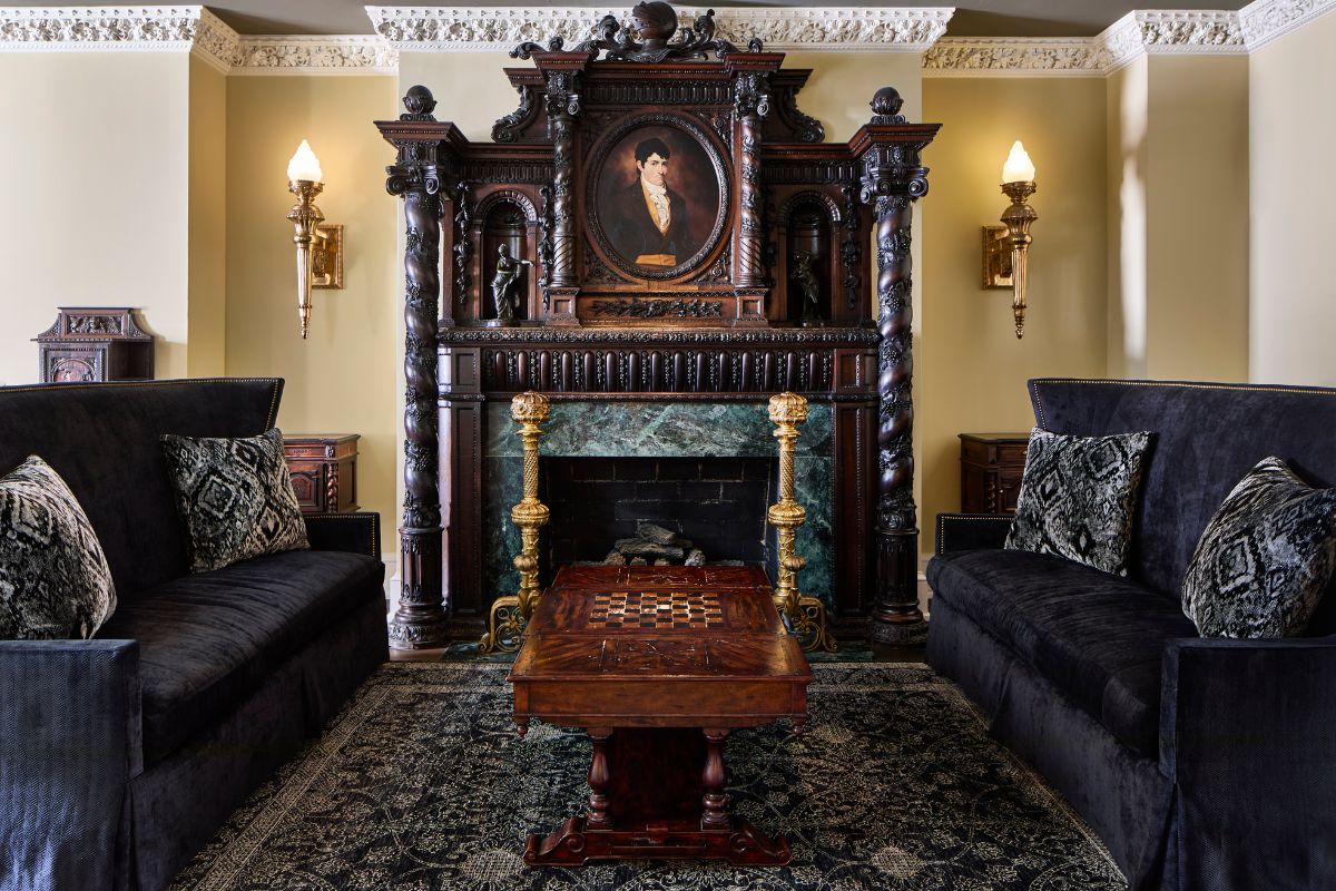 a room with a fireplace and a chess board table