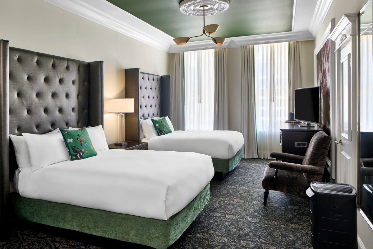 a room with two beds and a tv