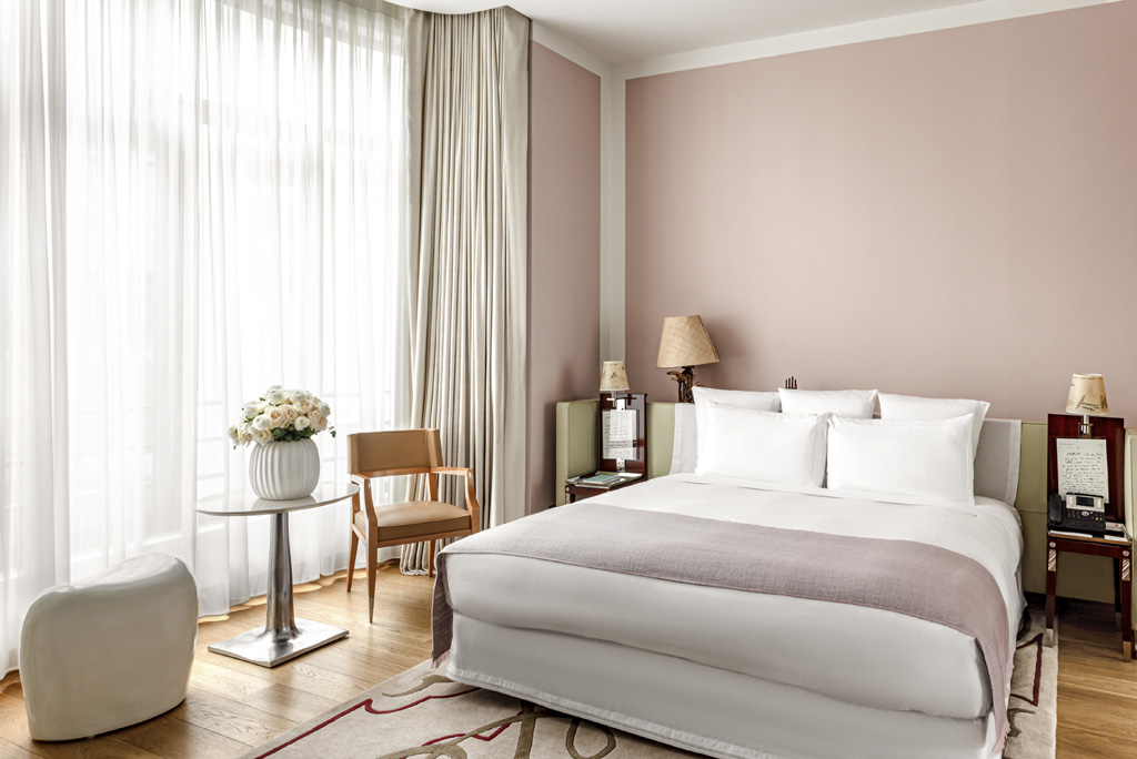 a bedroom with a bed and chairs