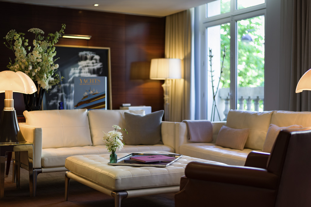 a living room with a couch and a vase of flowers