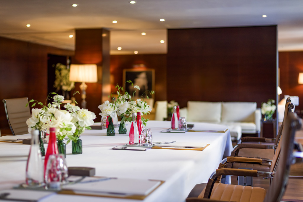 a table with white tablecloths and flowers in a room