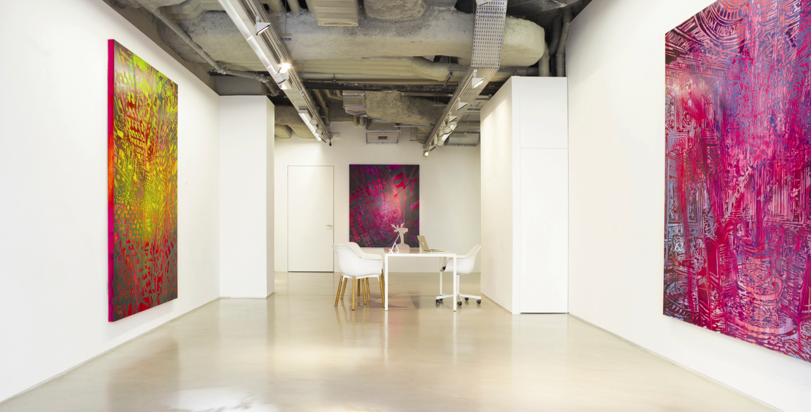 a white room with a desk and chairs