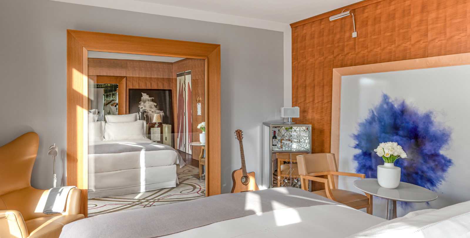 a bedroom with a guitar and a bed