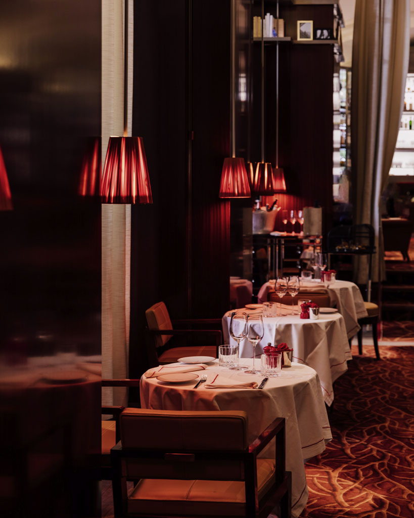 a row of tables with red lamps
