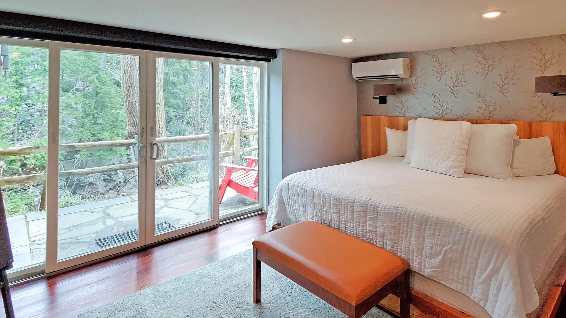 a bedroom with a bed and a bench