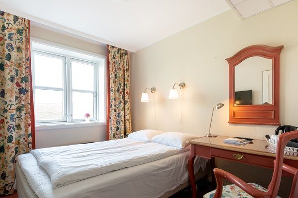 a bedroom with a desk and a bed
