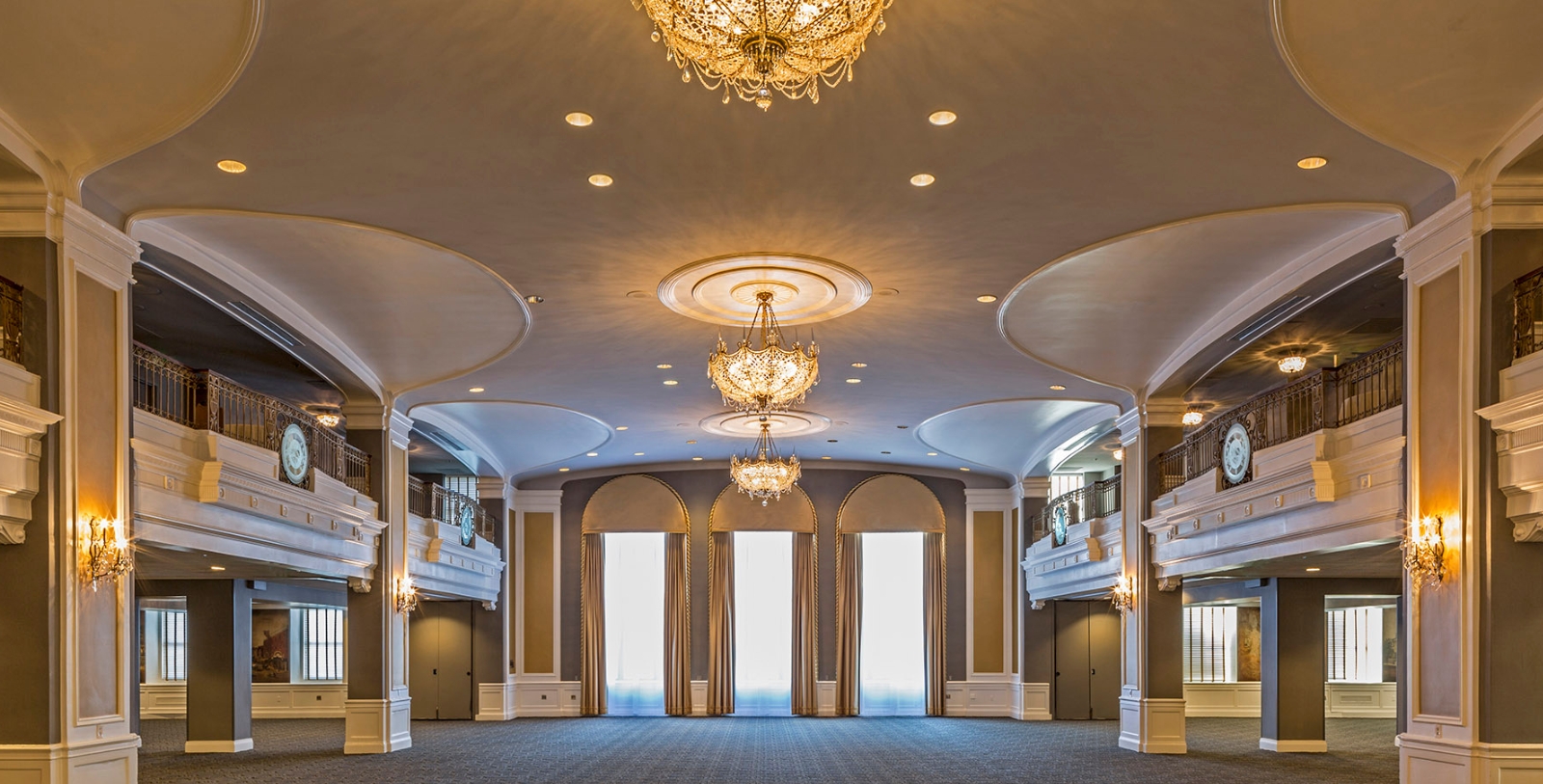 a large room with chandeliers and windows