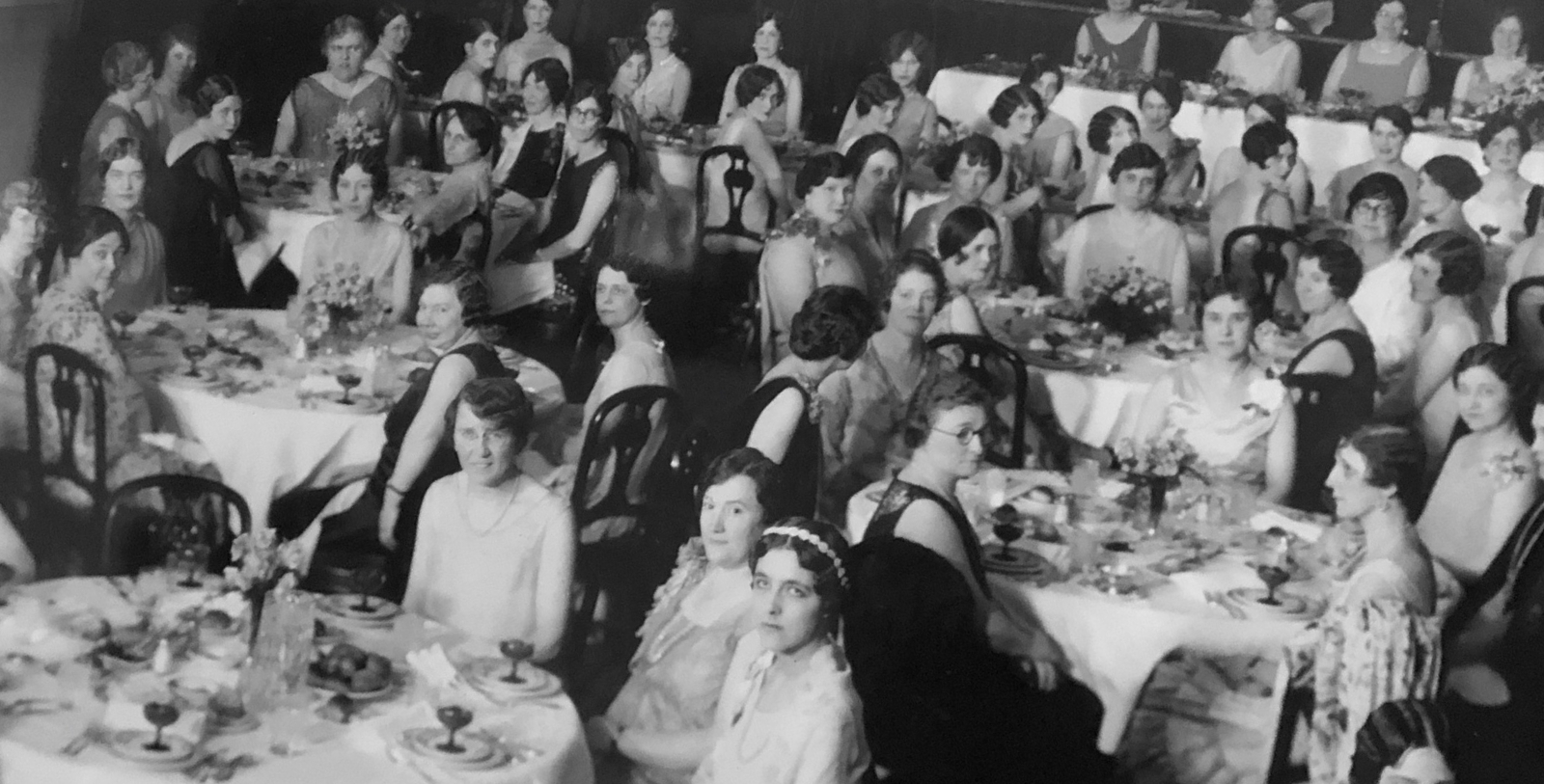 a group of women sitting at tables