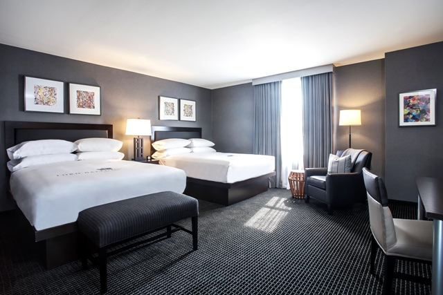 a room with two beds and a chair