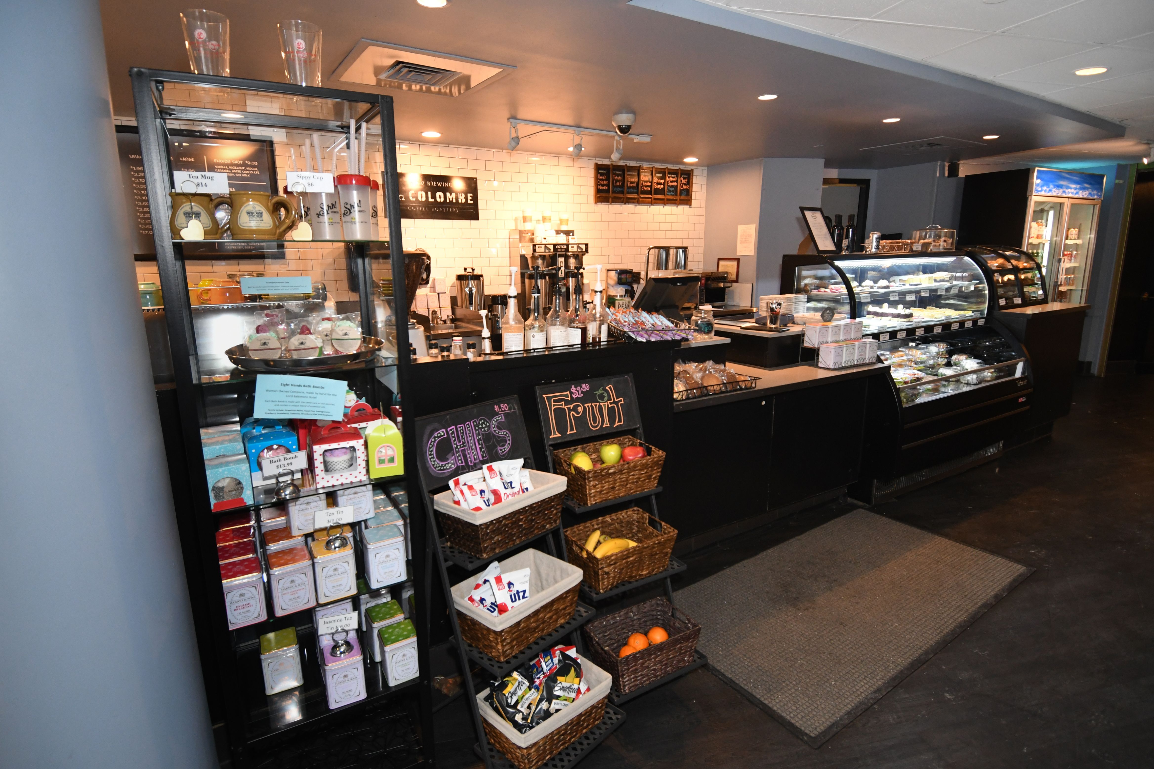 a coffee shop with shelves of food