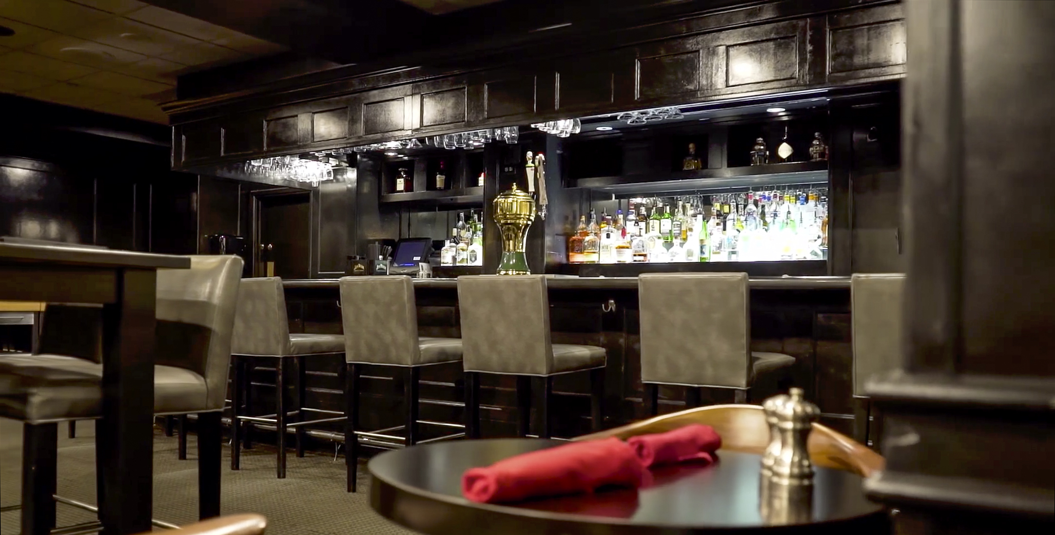 a bar with a table and chairs