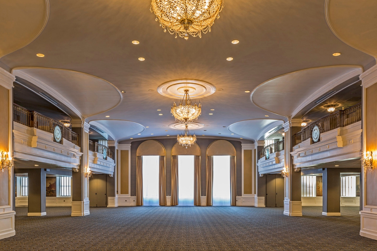 a large room with chandeliers and windows