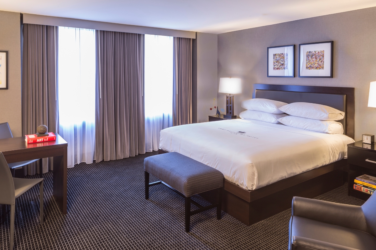 a bedroom with a bed and a chair