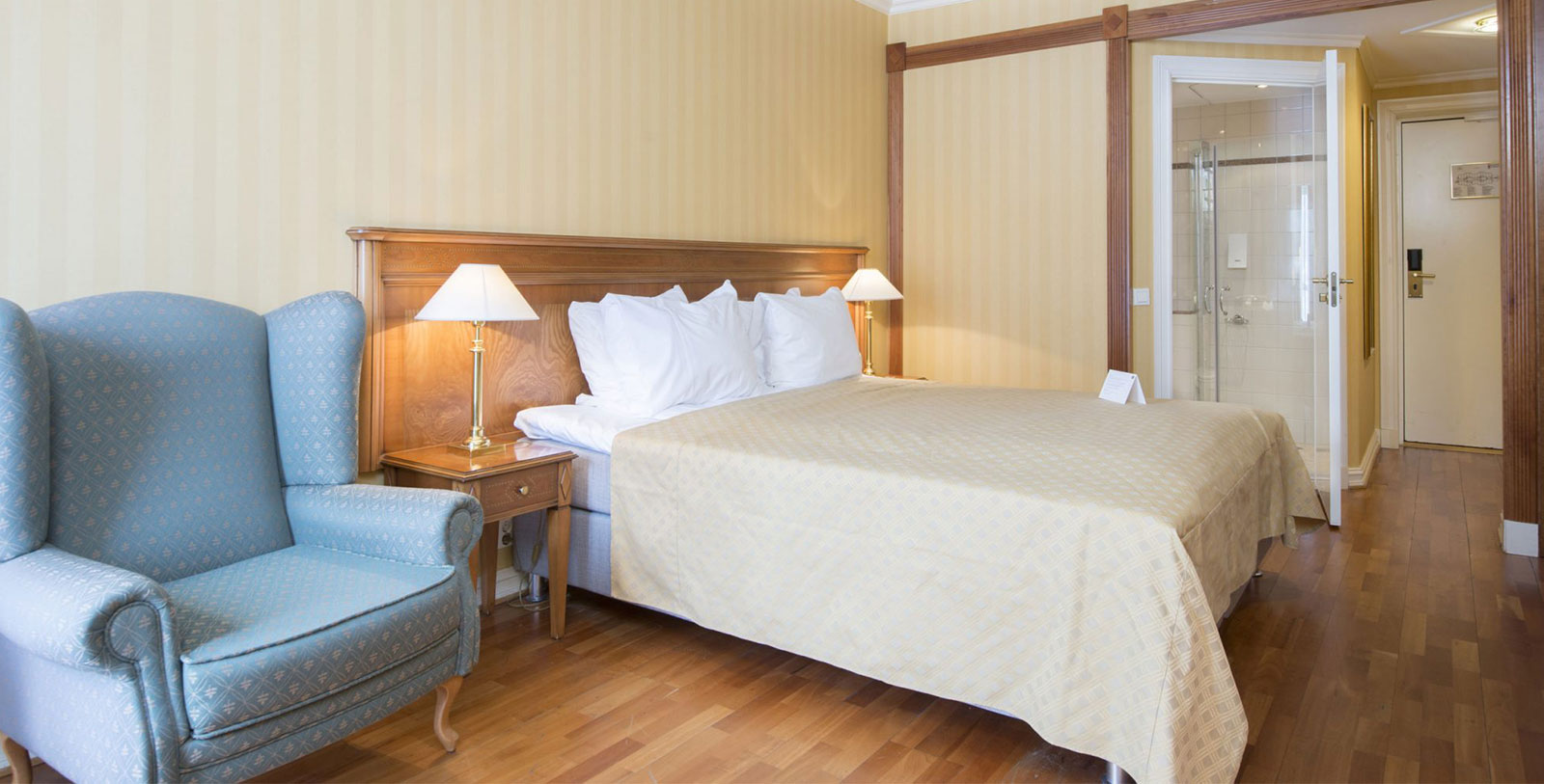 a bed with a lamp next to a chair