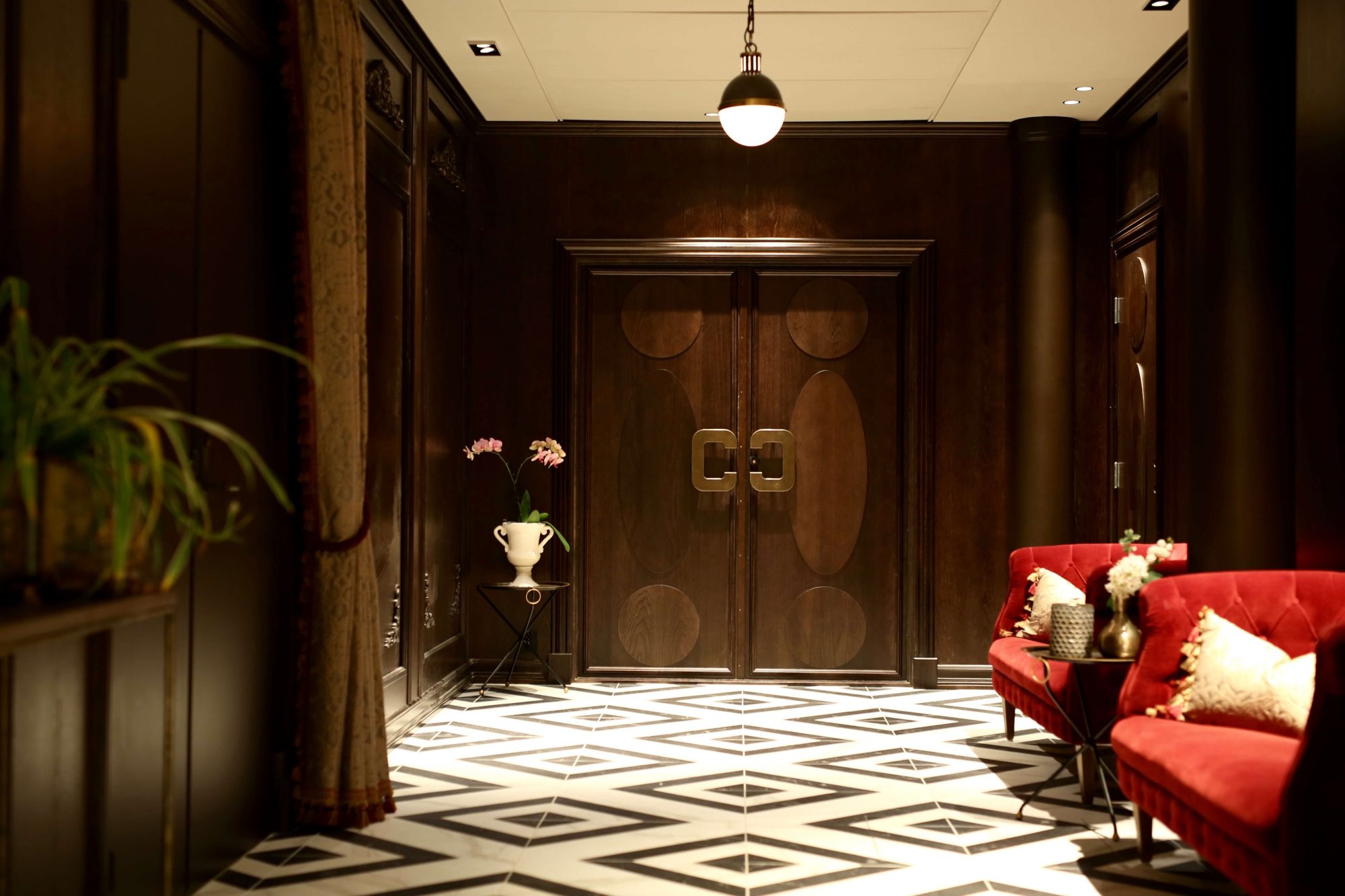 a room with a red couch and chairs