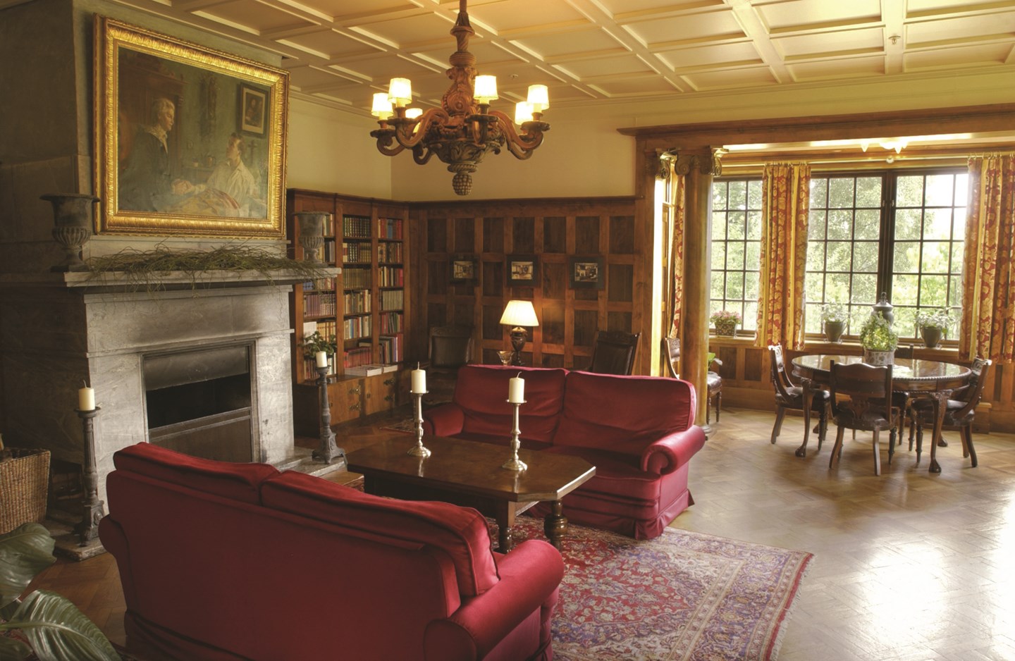 a living room with red couches and a fireplace