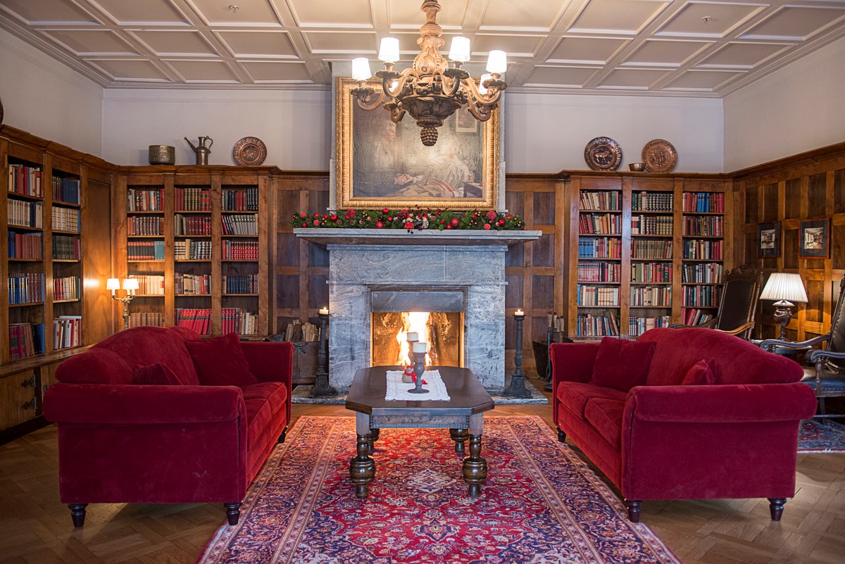 a room with a fireplace and red couches