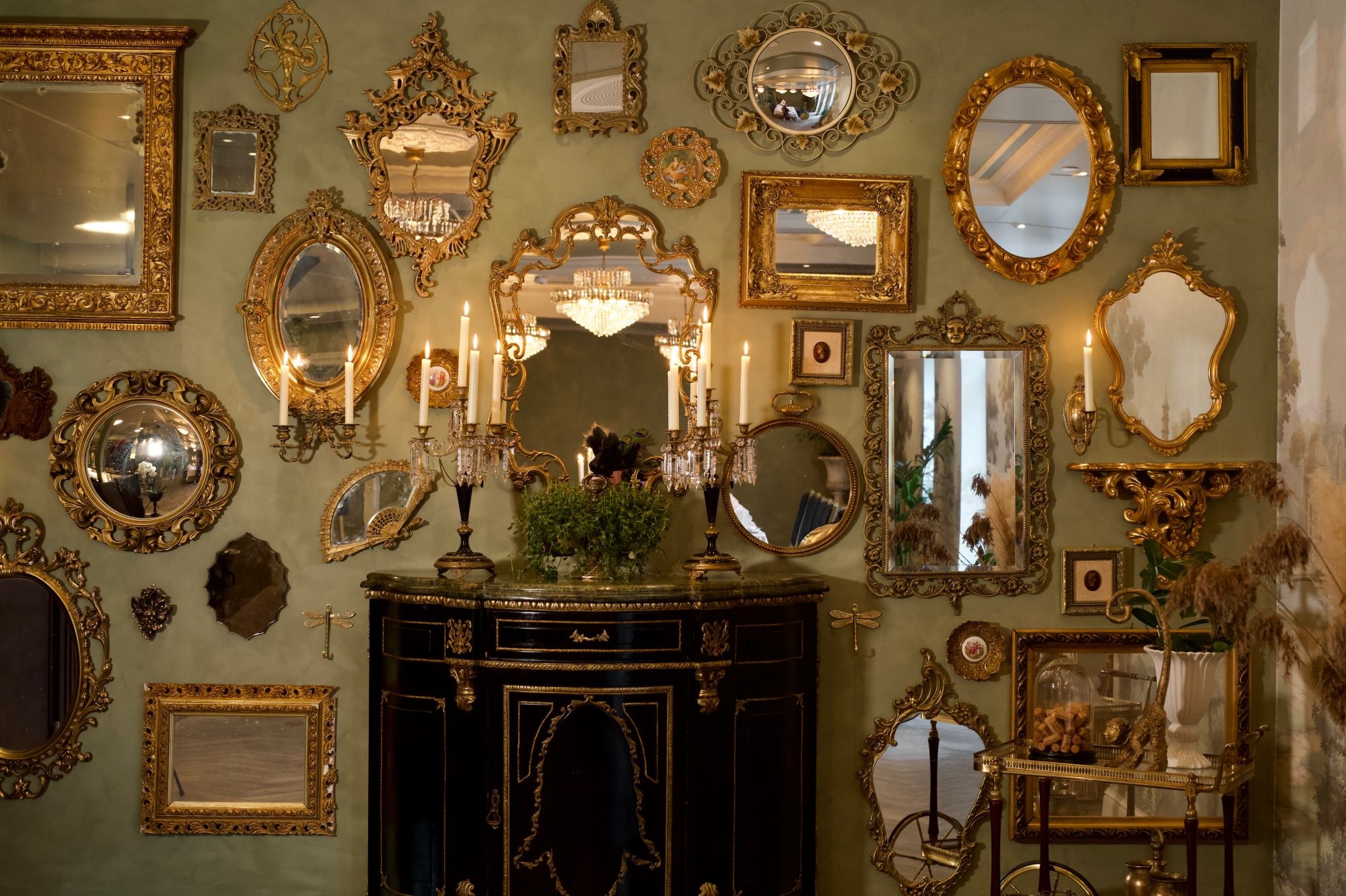 a wall with mirrors and candles