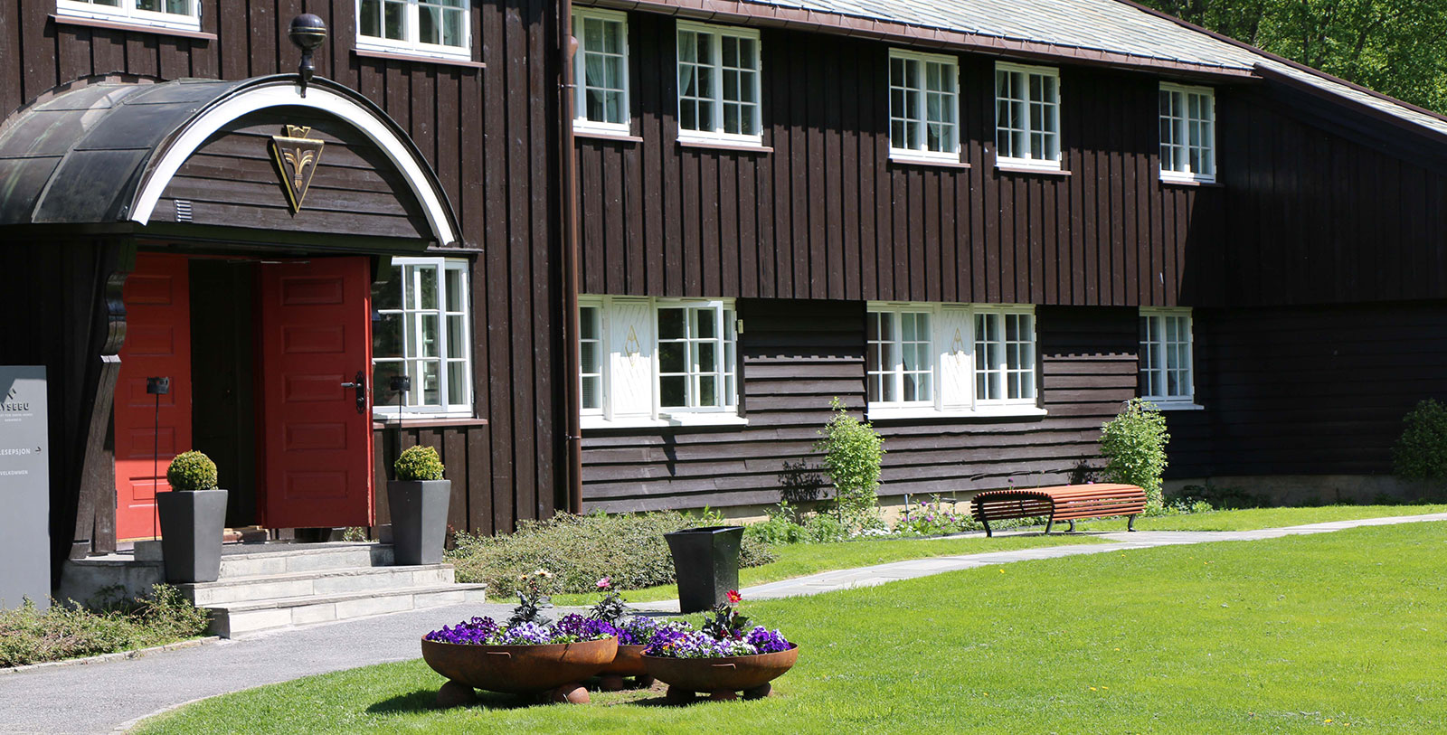 a building with a red door and a bench