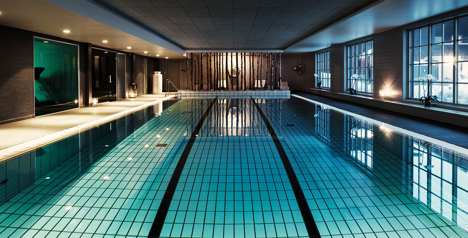 a indoor swimming pool with a large pool